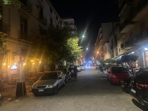 a city street at night with cars parked on the street at Maison Number11 in Caserta