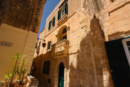 a building with a balcony on the side of it at 'Notabile' - Private Townhouse in Mdina in Mdina