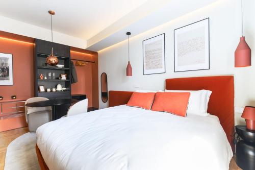 a bedroom with a large white bed with orange pillows at GL HOME in Como