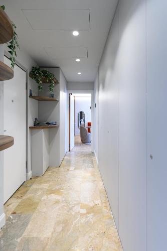 a hallway with white walls and a tile floor at GL HOME in Como