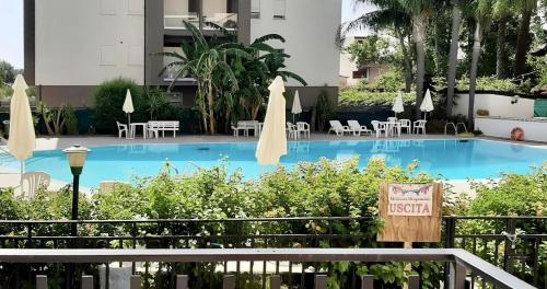 a large swimming pool with chairs and umbrellas at Griseo - Sicily Vista in Calatabiano
