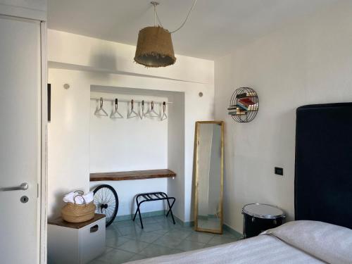 a bedroom with a mirror and a bed at Black Market Hotel in Ischia