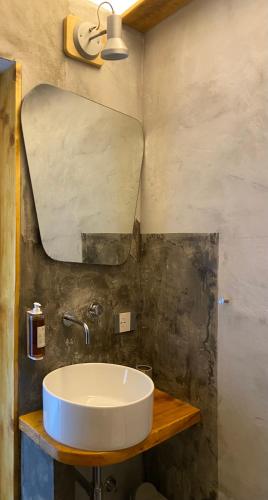 a bathroom with a sink and a mirror at Black Market Hotel in Ischia