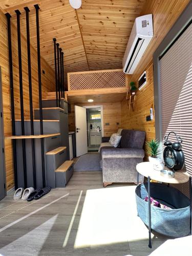 a living room with a couch and a staircase in a house at Ria süit otel bungalov in Rize