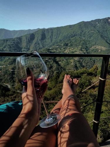 a person with their feet up with a glass of wine at The overlook cottage 2 in Keda