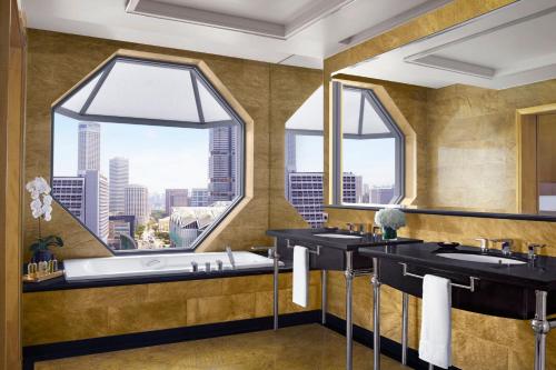 a bathroom with two sinks and a large window at The Ritz-Carlton, Millenia Singapore in Singapore
