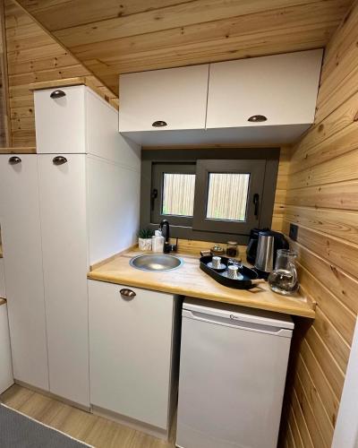 a kitchen with a sink and a counter top at Ria süit otel bungalov in Rize