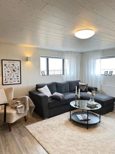 a living room with a couch and a table at Selið Farm Stay - Guesthouse in Álftanes