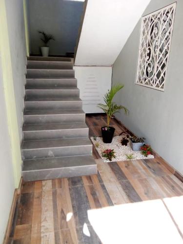 a staircase in a house with a stair case at Luxury Apartment By Merengue House in Boca Chica