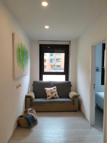 a living room with a couch and a window at Prim 9 izquierda in Bilbao