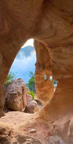 a view of a cave through a rock formation at Dana Gardens Hotel in Dana