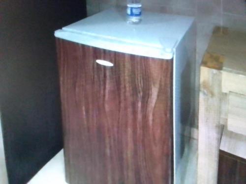 a wooden box with a bottle on top of it at Villa toscana Victoria island oniru in Lagos