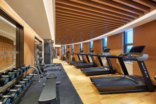 a gym with a row of treadmills and ellipticals at Fairfield by Marriott Guangzhou Konggang in Guangzhou