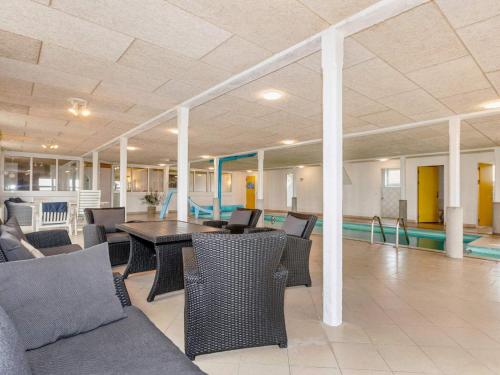 a lobby with a table and chairs and a pool at 20 person holiday home in Karby-By Traum in Karby