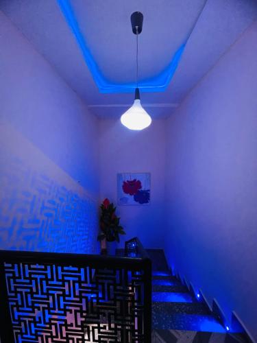 a room with a blue light on the ceiling at Apartments by Dee in Port Harcourt