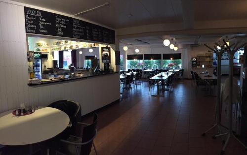 a dining room with tables and chairs in a restaurant at Hotel E-10 by First in Kiruna
