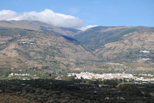 a view of a town in a mountain valley at Hotel Mirasol in Órgiva