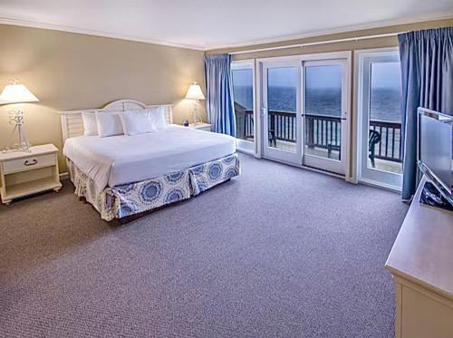 a bedroom with a bed and a balcony at Ocean View The Newport Overlook Two BR House Jamestown Across from Newport RI in Jamestown
