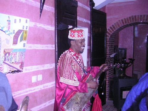 a man standing in a room with a guitar at Riad N10 in Marrakech