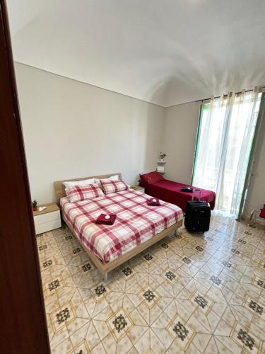 a bedroom with a bed and a large window at La Casetta di Romeo in Trapani