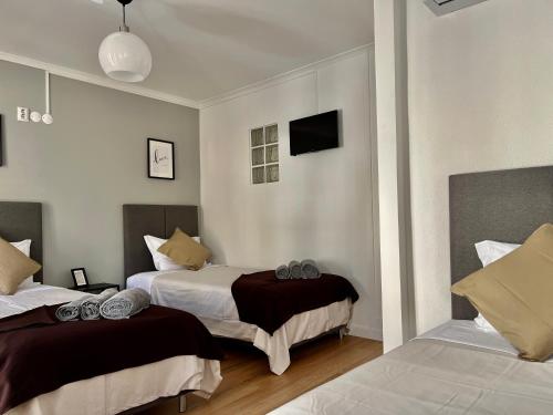 une chambre d'hôtel avec deux lits et une télévision dans l'établissement Mouraria - Apartamento, à Lisbonne