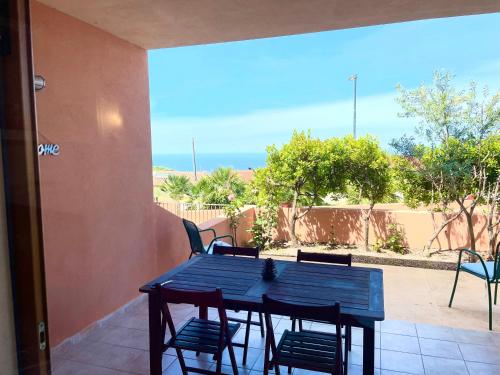 a blue table and chairs on a patio at Casa I Corbezzoli - Paduledda - Isola Rossa in Cascabraga