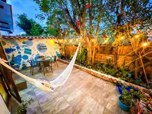 a patio with a hammock and a table and chairs at Casa Colonial en el corazón de Villa de Leyva Casa serena in Villa de Leyva