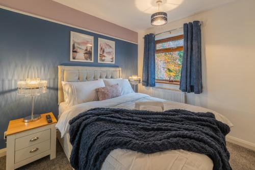 a bedroom with a large bed and a window at A Cosy Home from Home in Oldham