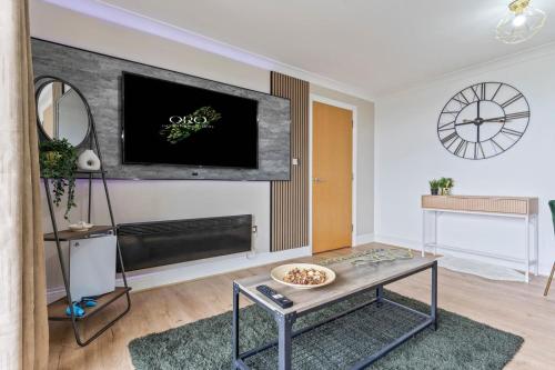 a living room with a flat screen tv on a wall at Central Birmingham 2 Bed with Balcony and City Views in Birmingham