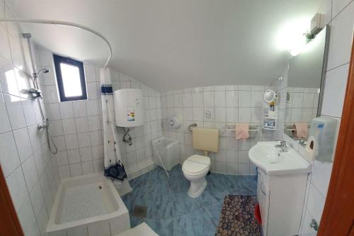 a bathroom with a toilet and a sink at Apartments by the sea Murter - 22397 in Murter