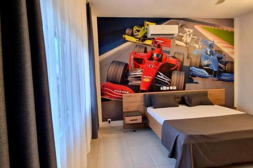 a bedroom with a bed and a racing car on the wall at Formule 1 in Lomé