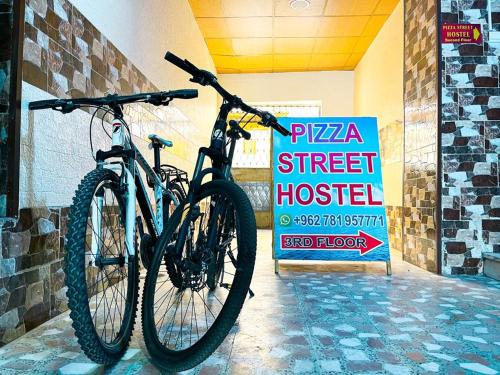 a bike parked next to a street hospital sign at Pizza Street Hostel in Aqaba