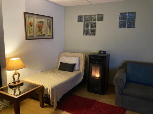 a small room with a bed and a table and a couch at Mar 11 a 100 mtros del mar in Parque del Plata
