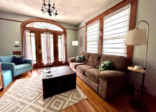 a living room with a couch and a table at Mid City 2 BR- beautiful, renovated Arts & Crafts Flat in New Orleans