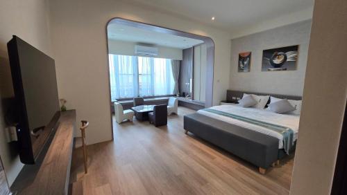a bedroom with a large bed and a large mirror at Senya Hotel in Hengchun South Gate