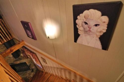 a picture of a cat on a wall at Amazing Cabin fireplace and stream #11 in Helen