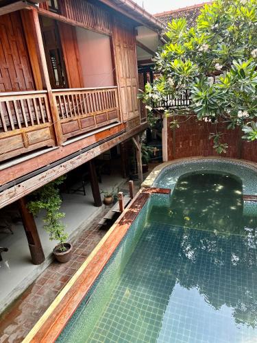 a swimming pool in front of a house at Tony's Place Ayutthaya in Phra Nakhon Si Ayutthaya
