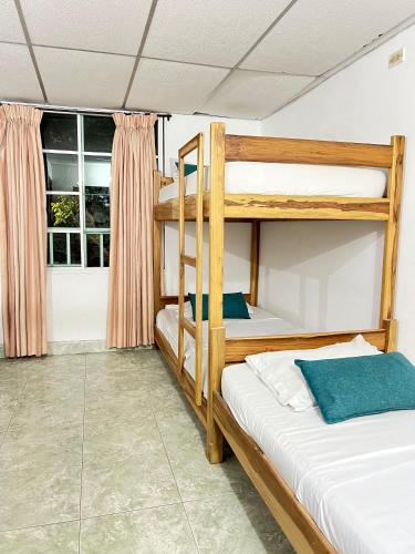 two bunk beds in a room with a window at Hotel Coco Beach in Santa Marta
