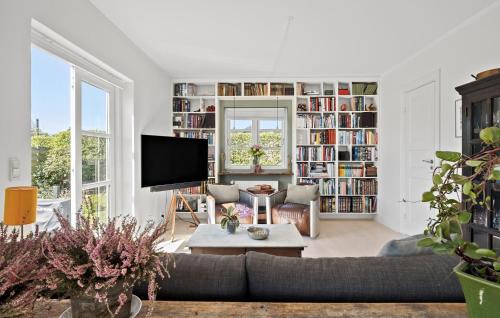 a living room with a couch and a tv at 2 Bedroom Pet Friendly Home In Hornbæk in Hornbæk