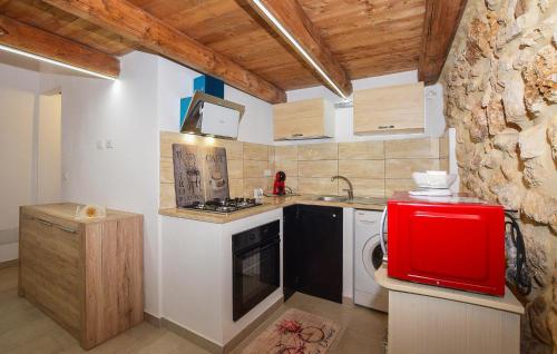 a small kitchen with a stove and a sink at Nice Apartment In Noto With Wifi in Noto