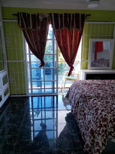 a bedroom with a bed and a large window at Cómodo aparta estudio in Concepción de La Vega