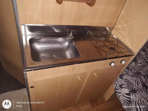 a stainless steel sink in a small kitchen at Casa Rodante en granja in Santiago del Estero