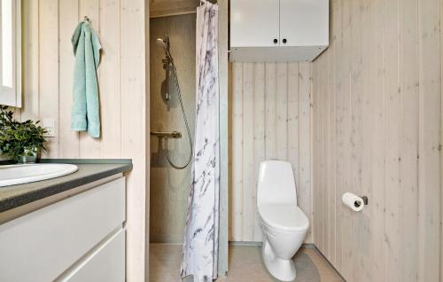 a bathroom with a toilet and a sink at 2 Bedroom Nice Home In Vordingborg in Vordingborg