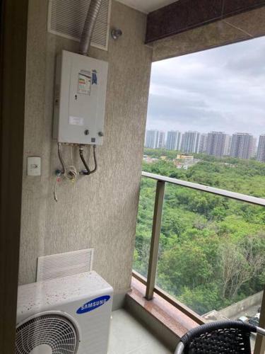 a room with a air conditioner and a large window at Via Première - Suíte - Riocentro - Barra Olímpica - Vista Panorâmica in Rio de Janeiro