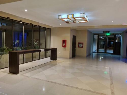 an empty lobby with a table in a building at Apart dos ambientes - Macrocentro Salta in Salta