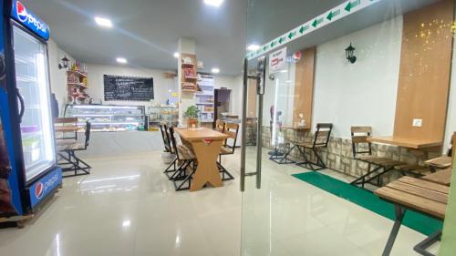 a restaurant with tables and chairs in a store at Gorkha Chhen bed & breakfast in Gorkhā