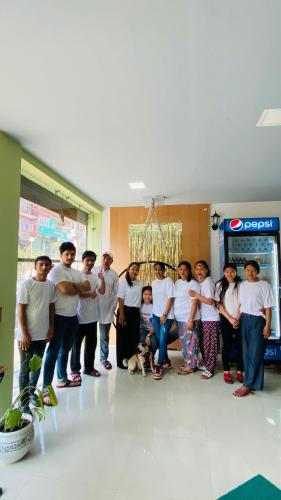 a group of people posing for a picture in a room at Gorkha Chhen bed & breakfast in Gorkhā