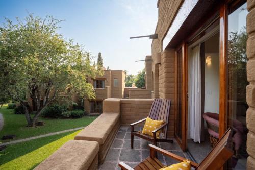 a patio with a chair and a window at Mision del Sol Resort & Spa Adults Only in Cuernavaca
