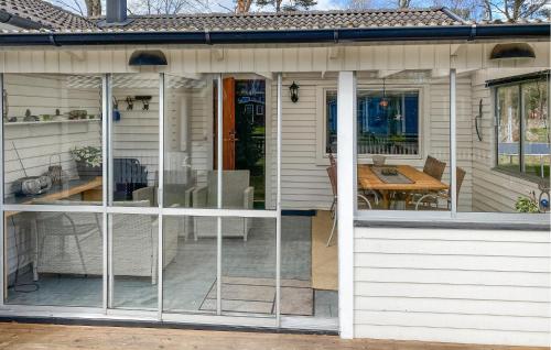 a screened in porch of a house with a table at 2 Bedroom Stunning Home In Bergkvara in Bergkvara