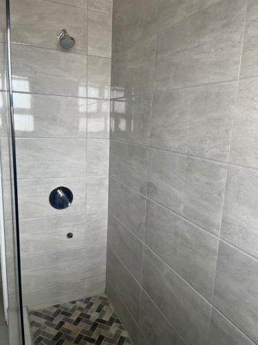 a bathroom with a shower with a glass door at 10 Glen Court in Durban